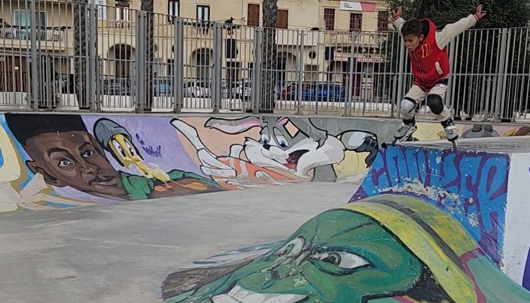 Older kids skating at a skatepark with pads